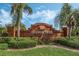 Brick entrance sign for Orange Tree community, featuring palm trees and landscaping at 16208 Magnolia Hill St, Clermont, FL 34714