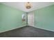 Light green bedroom with window and double doors at 16208 Magnolia Hill St, Clermont, FL 34714