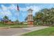 Ornate brick entrance with a flagpole and the name Orange Tree, showing a welcoming atmosphere at 16208 Magnolia Hill St, Clermont, FL 34714