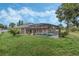 Expansive backyard with lush lawn and screened-in pool at 16208 Magnolia Hill St, Clermont, FL 34714