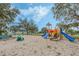 playground with swings, slides, and climbing structures in a sandy play area at 16208 Magnolia Hill St, Clermont, FL 34714