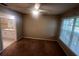 Bedroom with brown carpet, large window, and a view of the bathroom at 6312 Raleigh St # 513, Orlando, FL 32835