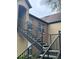 Exterior view of condo building with a metal staircase leading to the entrance at 6312 Raleigh St # 513, Orlando, FL 32835