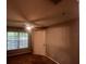 Bedroom with brown carpet, window with blinds, and a door at 6312 Raleigh St # 513, Orlando, FL 32835