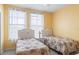 Twin bedroom with floral bedding and two windows at 720 Celebration Ave # 220, Celebration, FL 34747