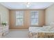 Bedroom with a double bed, dresser, and two large windows at 720 Celebration Ave # 220, Celebration, FL 34747