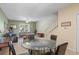 Glass-topped dining table with four chairs in an open living space at 720 Celebration Ave # 220, Celebration, FL 34747