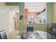 View of a kitchen with white cabinets and an orange accent wall at 720 Celebration Ave # 220, Celebration, FL 34747