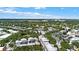 Aerial view showcasing a town's layout, including a lake and residential neighborhoods at 720 Celebration Ave # 220, Celebration, FL 34747