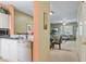 Kitchen with white cabinets, stainless steel appliances, and view to living room at 720 Celebration Ave # 220, Celebration, FL 34747