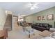 Living room with seating area and a view into the kitchen and dining area at 720 Celebration Ave # 220, Celebration, FL 34747