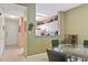 Dining area with a glass table and kitchen with white cabinets at 720 Celebration Ave # 220, Celebration, FL 34747