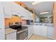 Kitchen with white cabinets, stainless steel appliances and view to living room at 720 Celebration Ave # 220, Celebration, FL 34747