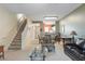 Open living space with stairs, seating area and a glimpse of the kitchen at 720 Celebration Ave # 220, Celebration, FL 34747