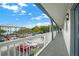 Hallway overlooking parking lot with white railings and blue doors at 720 Celebration Ave # 220, Celebration, FL 34747