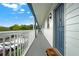 Hallway with white railings and blue doors leading to individual units at 720 Celebration Ave # 220, Celebration, FL 34747