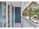 Private balcony with French doors overlooking a tree-lined street at 720 Celebration Ave # 220, Celebration, FL 34747