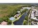Aerial view of community with lake, tennis courts, and residential buildings at 720 Celebration Ave # 220, Celebration, FL 34747