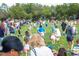 Children enjoying an Easter egg hunt on a grassy field at 720 Celebration Ave # 220, Celebration, FL 34747