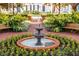 Charming courtyard with a two-tiered fountain and colorful flowers at 720 Celebration Ave # 220, Celebration, FL 34747