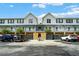 Exterior view of townhomes with parking and a courtyard at 720 Celebration Ave # 220, Celebration, FL 34747