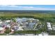 Aerial view showcasing a town's beautiful lake and buildings at 720 Celebration Ave # 220, Celebration, FL 34747