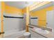 Full bathroom with single vanity and tub at 720 Celebration Ave # 220, Celebration, FL 34747