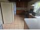 Simple kitchen with wood cabinets and tile flooring at 10 Mccarthy Ave, Frostproof, FL 33843