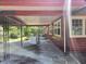Covered carport area adjacent to the house with washer and dryer at 10 Mccarthy Ave, Frostproof, FL 33843