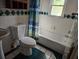 Small bathroom with tub, toilet, and patterned shower curtain at 10 Mccarthy Ave, Frostproof, FL 33843