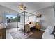 Bright bedroom with a four-poster bed and wood-look floors at 1052 Lotus Cove Ct # 743, Altamonte Springs, FL 32714