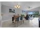 Elegant dining area with a chandelier and seating for four, near the living room at 1052 Lotus Cove Ct # 743, Altamonte Springs, FL 32714