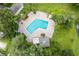 Community pool with surrounding patio and lounge chairs at 1052 Lotus Cove Ct # 743, Altamonte Springs, FL 32714