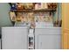 Bright laundry room with washer, dryer, and shelving for storage at 1052 Lotus Cove Ct # 743, Altamonte Springs, FL 32714