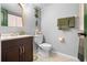 Clean bathroom with dark vanity, light-colored toilet, and beach-themed decor at 1052 Lotus Cove Ct # 743, Altamonte Springs, FL 32714
