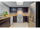 Functional kitchen with dark cabinetry, stainless steel appliances, and tile flooring at 1052 Lotus Cove Ct # 743, Altamonte Springs, FL 32714
