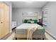Guest bedroom with light teal bedding and wood closet doors at 1052 Lotus Cove Ct # 743, Altamonte Springs, FL 32714