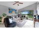 Cozy living room featuring a comfy sofa, large windows, and balcony access at 1052 Lotus Cove Ct # 743, Altamonte Springs, FL 32714