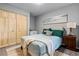 Guest bedroom with light teal bedding and wood closet doors at 1052 Lotus Cove Ct # 743, Altamonte Springs, FL 32714