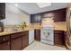 Well-equipped kitchen featuring dark wood cabinets and stainless steel appliances at 1052 Lotus Cove Ct # 743, Altamonte Springs, FL 32714