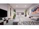 Spacious bedroom with a striped bedspread and plenty of windows at 209 N Pine Ave, Oviedo, FL 32765