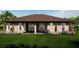 Single-story home with a covered patio and well-manicured lawn at 209 N Pine Ave, Oviedo, FL 32765