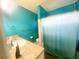 Clean bathroom with teal walls, shower/tub combo, and vanity with countertop at 3206 Sherry Dr, Orlando, FL 32810