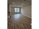 Spacious living room featuring hardwood floors and large windows at 14315 Sapelo Beach Dr, Orlando, FL 32827