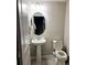 Small half bathroom with pedestal sink and toilet at 14315 Sapelo Beach Dr, Orlando, FL 32827