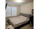 Second bedroom with king-size bed and window blinds at 14315 Sapelo Beach Dr, Orlando, FL 32827