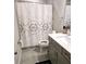 Clean bathroom with gray vanity and patterned shower curtain at 14315 Sapelo Beach Dr, Orlando, FL 32827