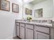 Double vanity bathroom with granite countertop and gray cabinets at 7137 Painted Bunting Way, Saint Cloud, FL 34773