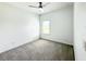 Small bedroom with gray carpet, ceiling fan, and window with blinds at 4762 Riverwalk Dr, Saint Cloud, FL 34771