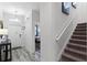 Entryway with tile floor, stairs, and view into bedroom at 1638 Moon Valley Dr, Davenport, FL 33896